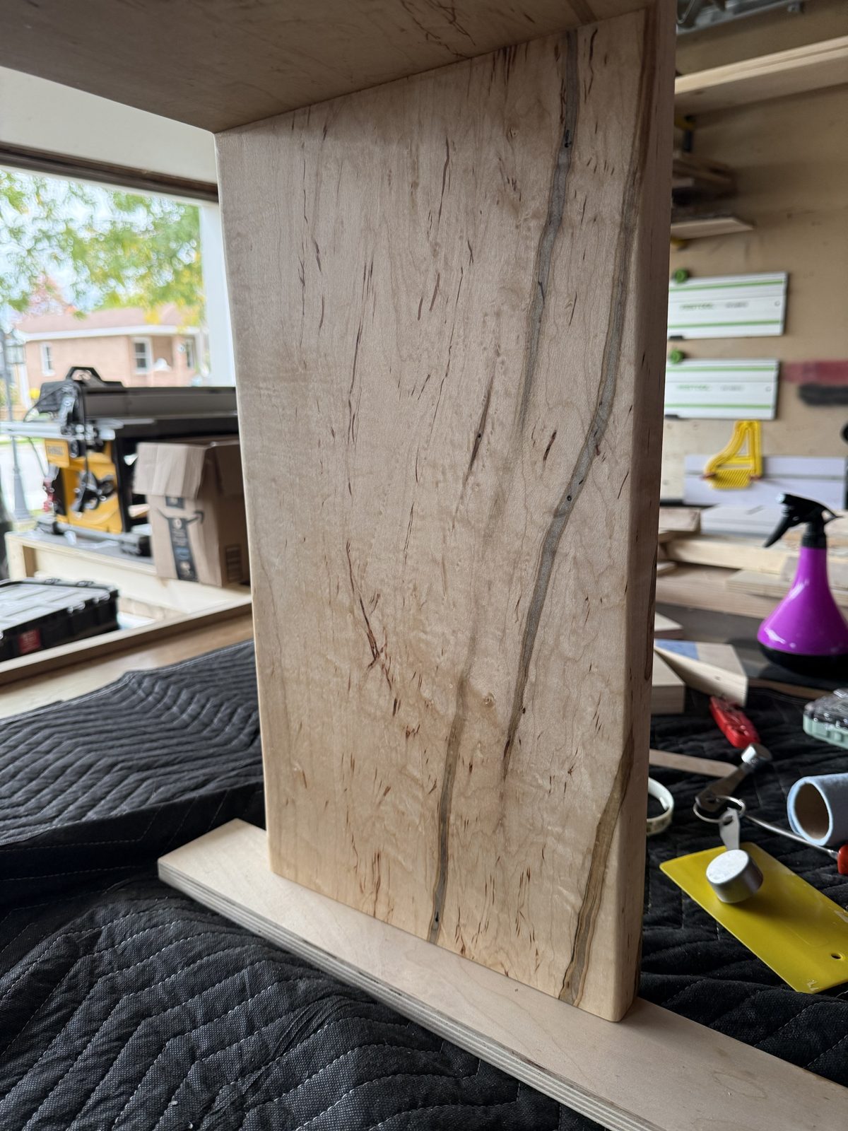 Side panel of the wormy maple ottoman tray table